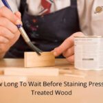 how long to wait before staining pressure treated wood